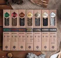 Row of incense packaging boxes on a textured surface