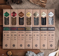 Row of incense packaging boxes on a textured surface